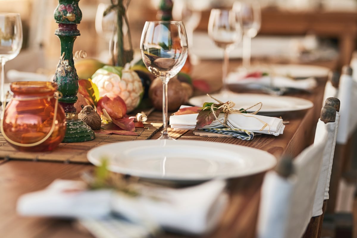 A beautifully set dinner table with plates and glasses at a private celebration